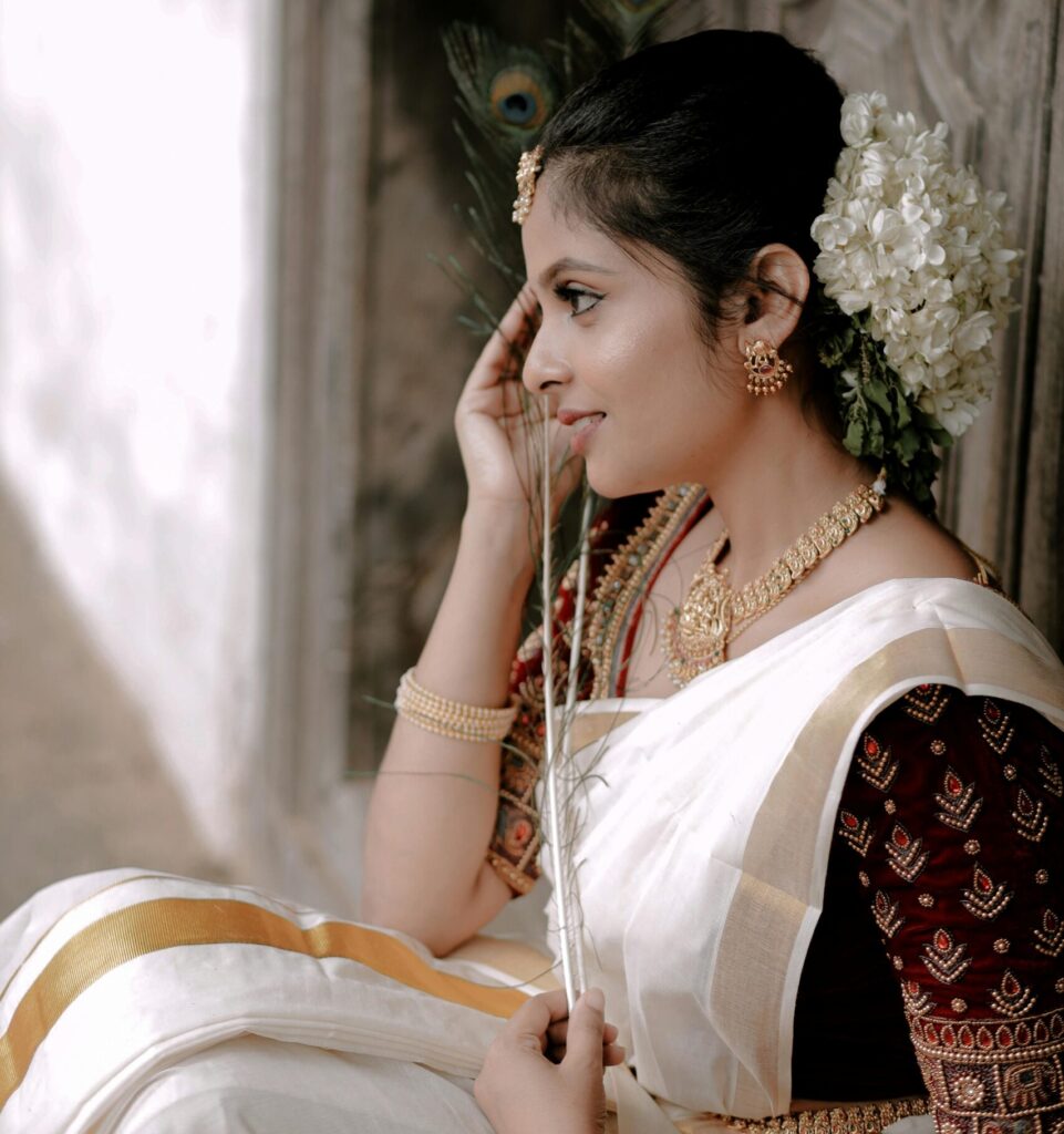 Portrait of a smiling woman in traditional Indian attire, exuding cultural elegance.