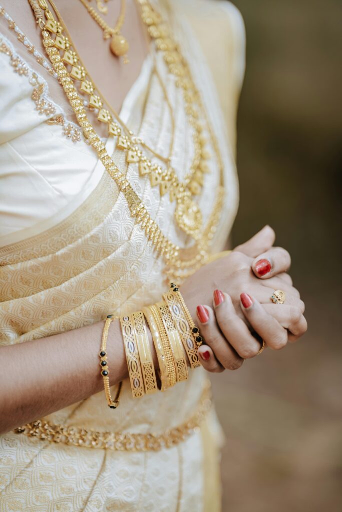 Beautifully adorned Indian bride in traditional gold jewelry and saree.
